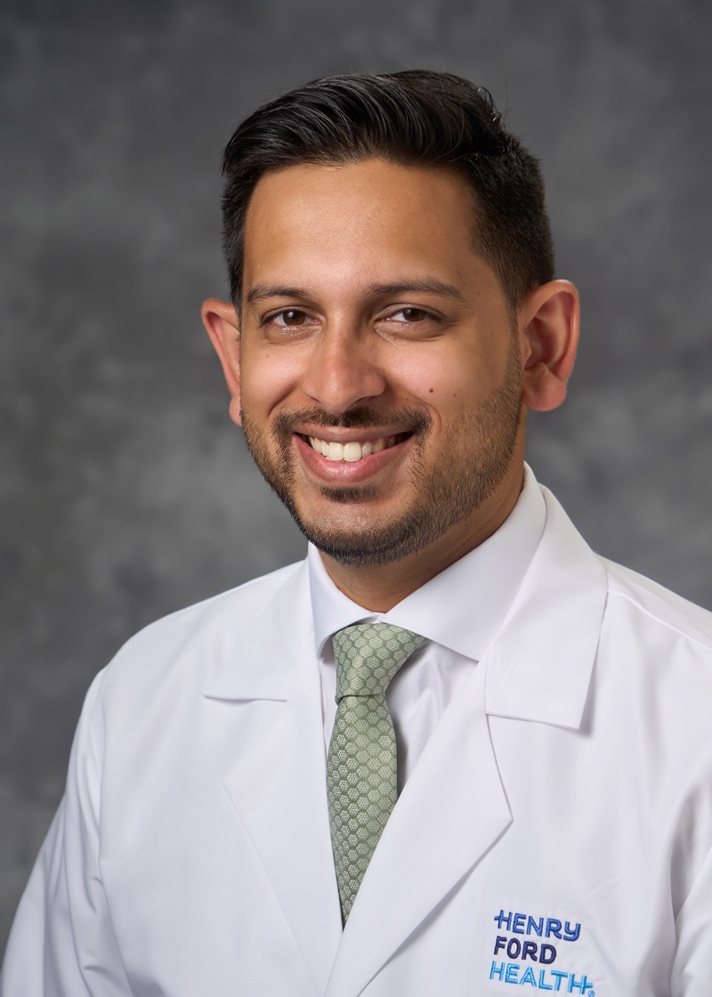 Humza Nusrat in a white coat